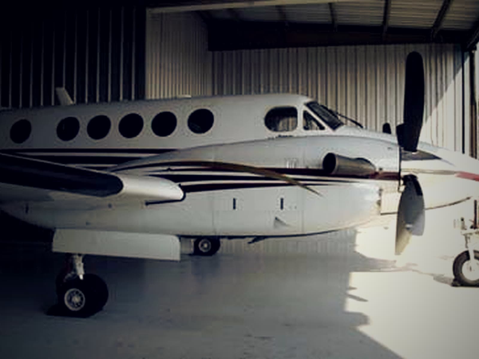 A Beechcraft King Air inside the Foothills Aviation hangar at KTOC.